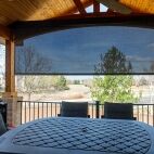 Deck with outdoor dining and patio shades