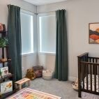 nursery with white blackout shades and white fascia