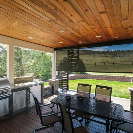 Outdoor kitchen with manual patio shade