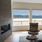 Solar screen roller shades in living room with modern fire place