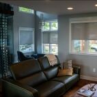 grey solar screen shades with white fascia in living room with wine cellar